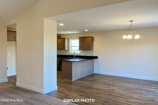 kitchen with sink, dishwasher, a chandelier, hanging light fixtures, and lofted ceiling