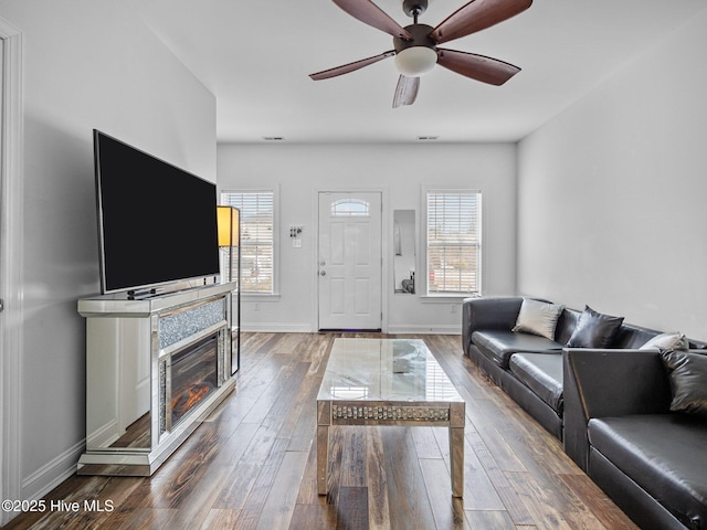 living room featuring ceiling fan and hardwood / wood-style floors