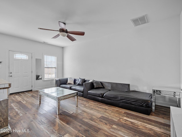 living room with dark hardwood / wood-style floors and ceiling fan