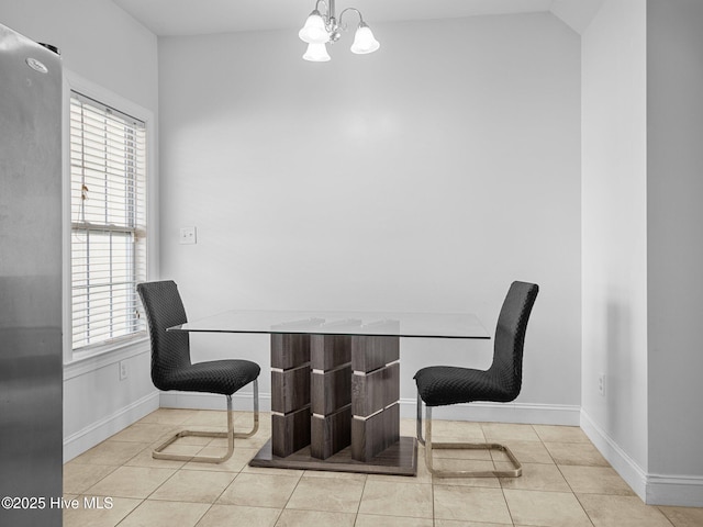 tiled dining room with an inviting chandelier