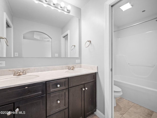 full bathroom with toilet, tile patterned floors, shower / tub combination, and vanity