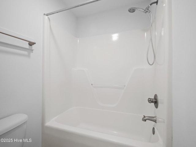 bathroom with toilet and tub / shower combination