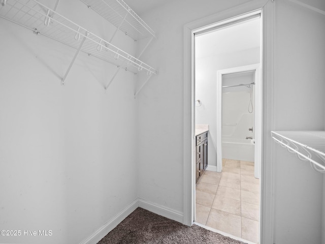 spacious closet with light tile patterned flooring