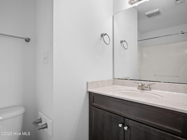 bathroom featuring toilet and vanity