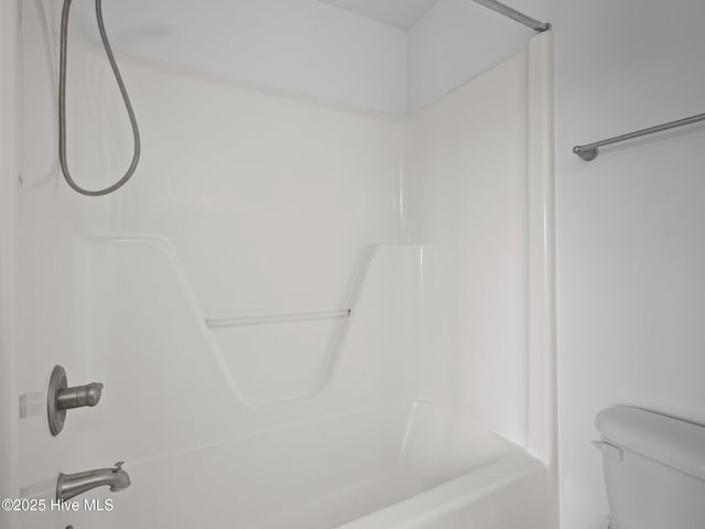 bathroom with shower / tub combination and toilet