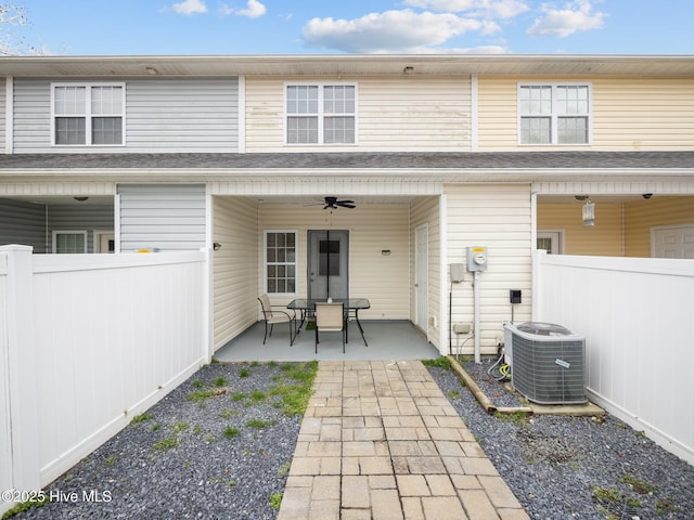 rear view of house with ceiling fan, a patio area, and central AC