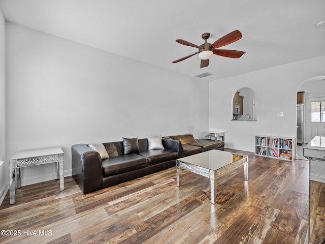 living room with ceiling fan and wood-type flooring