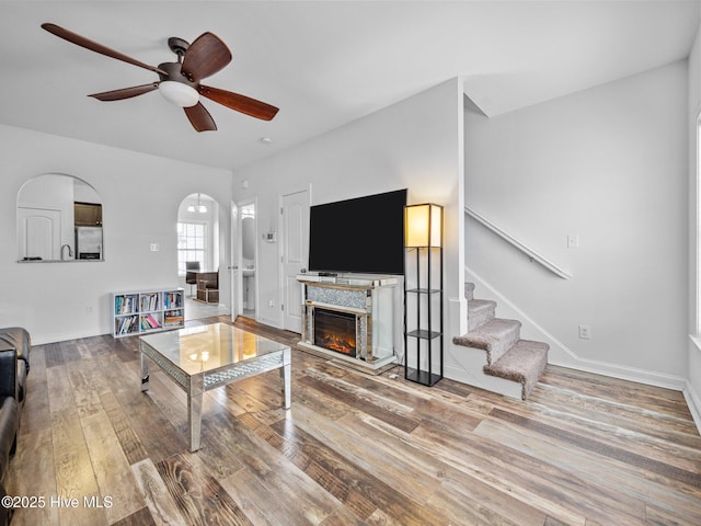 living room featuring ceiling fan and hardwood / wood-style floors