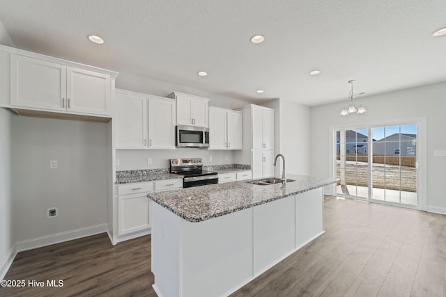 kitchen with white cabinetry, sink, stone countertops, and appliances with stainless steel finishes