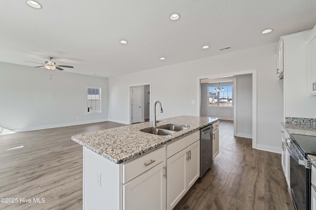 kitchen with white cabinets, sink, a kitchen island with sink, and stainless steel appliances