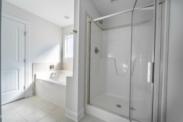 bathroom with tile patterned floors and independent shower and bath