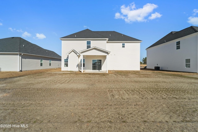 rear view of house featuring central AC unit and a patio