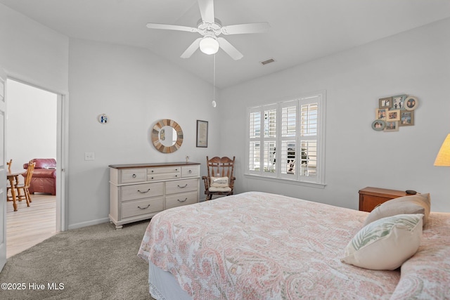 bedroom featuring lofted ceiling, light carpet, and ceiling fan