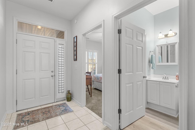 tiled foyer entrance with sink