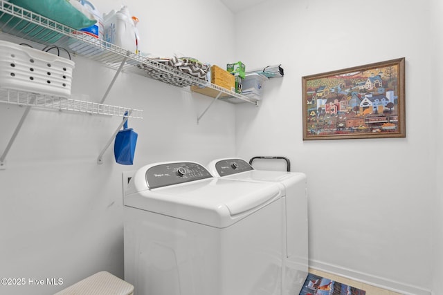 washroom with washing machine and clothes dryer