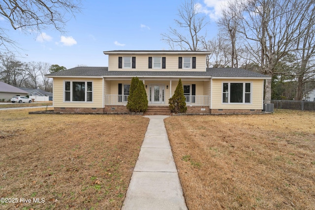 view of front of property featuring central air condition unit, a front yard, and covered porch