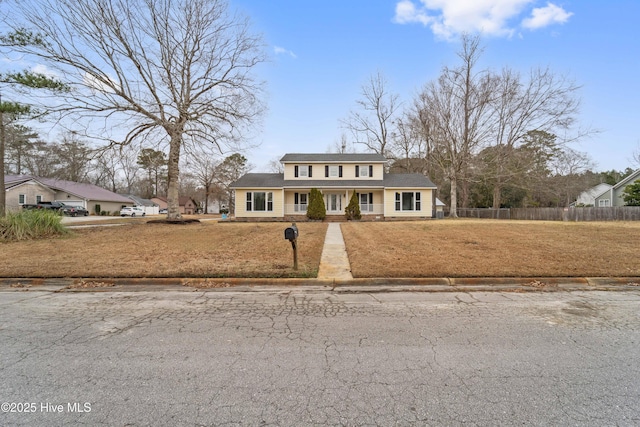 view of front of property featuring covered porch and a front lawn