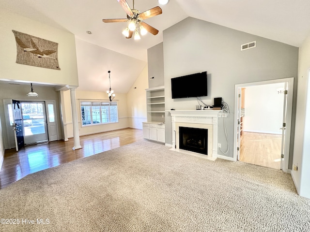 6104 Falcon Dr, New Bern, NC 28560 - unfurnished living room featuring carpet, high vaulted ceiling, ornate columns, ceiling fan, and a fireplace with flush hearth