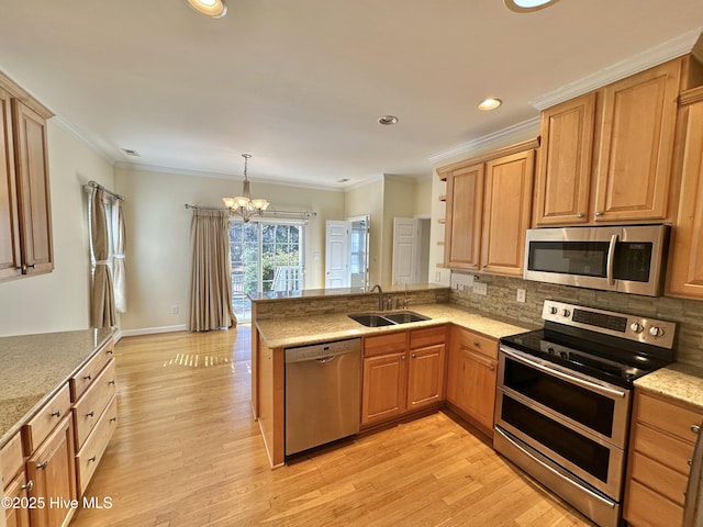 6104 Falcon Dr, New Bern, NC 28560 - kitchen with stainless steel appliances, a peninsula, a chandelier, decorative backsplash, and recessed lighting