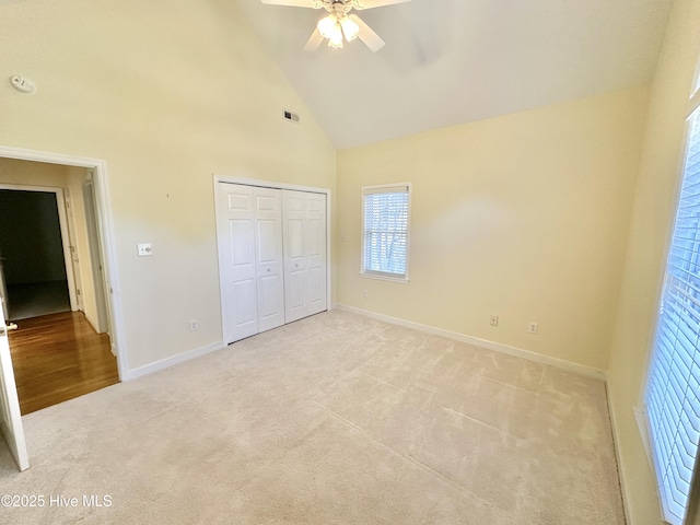 6104 Falcon Dr, New Bern, NC 28560 - unfurnished bedroom featuring light colored carpet, high vaulted ceiling, a closet, and a ceiling fan