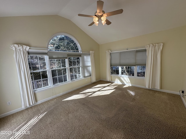 spare room featuring a ceiling fan, carpet flooring, vaulted ceiling, and baseboards