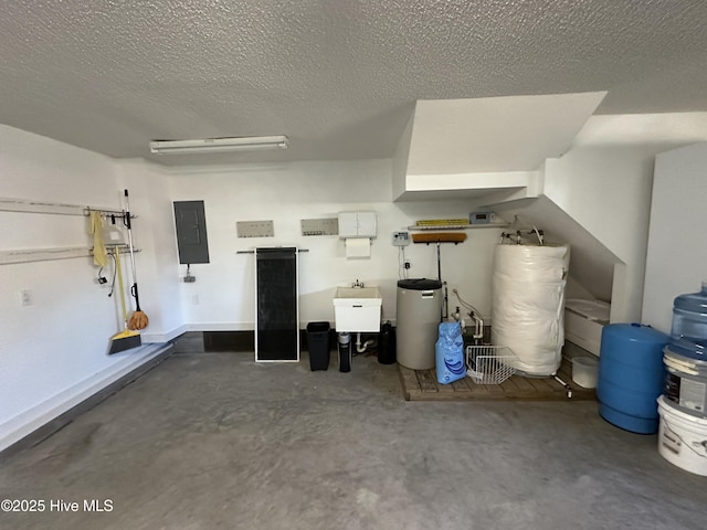 garage with electric panel, a sink, and water heater