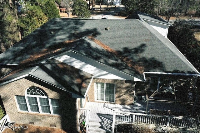 view of property exterior with crawl space and brick siding