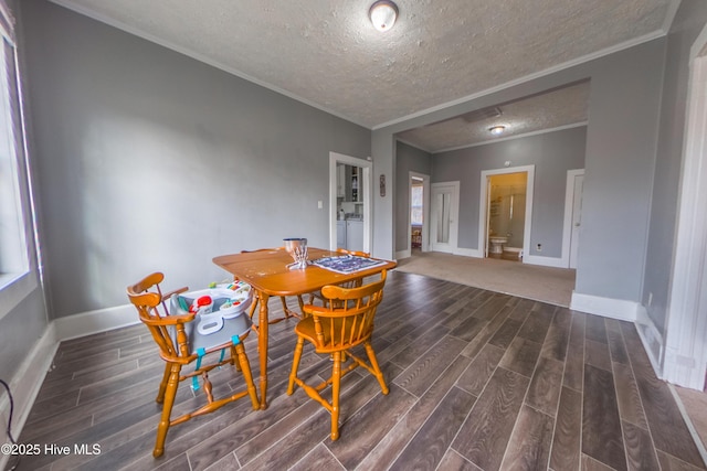 dining space featuring washer and clothes dryer, a textured ceiling, and crown molding