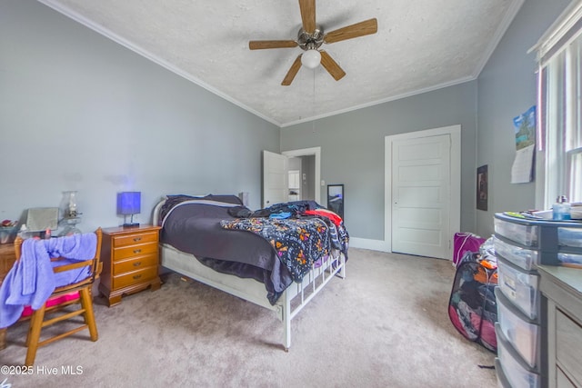 carpeted bedroom with ceiling fan, ornamental molding, and a textured ceiling