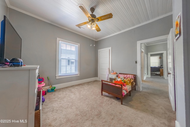 carpeted bedroom featuring ceiling fan and crown molding