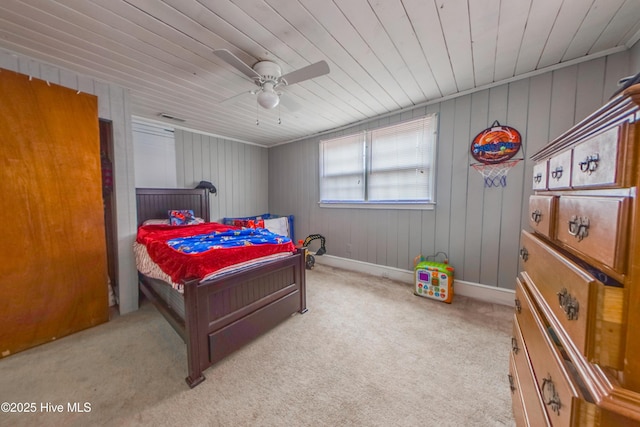 carpeted bedroom with wood walls, ceiling fan, and wood ceiling