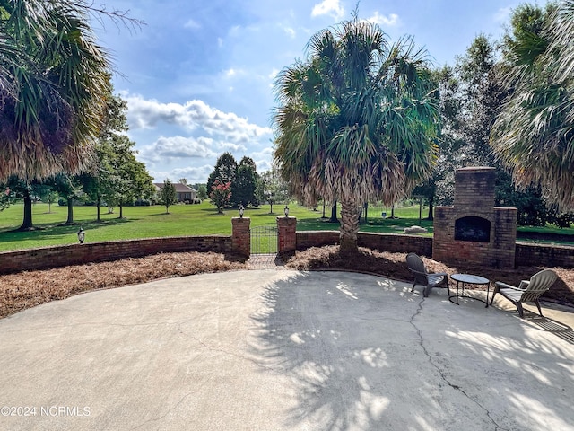 view of patio featuring an outdoor stone fireplace