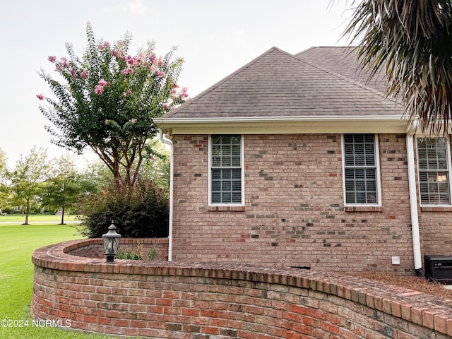 view of side of property with a yard