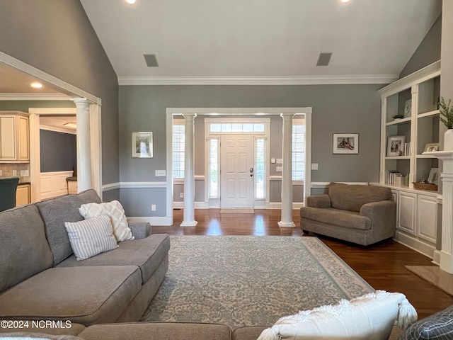 living room with dark hardwood / wood-style flooring, decorative columns, vaulted ceiling, and ornamental molding