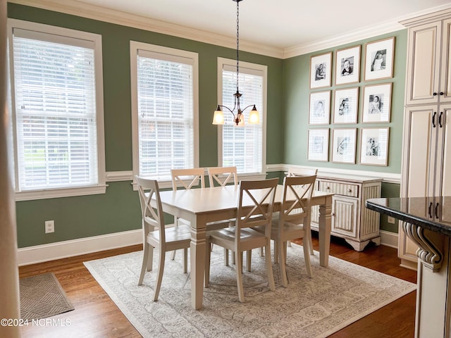 dining space featuring a wealth of natural light, dark wood-type flooring, and a notable chandelier