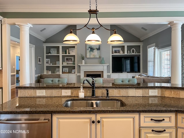 kitchen with vaulted ceiling, sink, stainless steel dishwasher, and decorative light fixtures