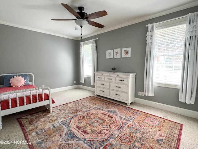 carpeted bedroom featuring multiple windows, ceiling fan, and ornamental molding