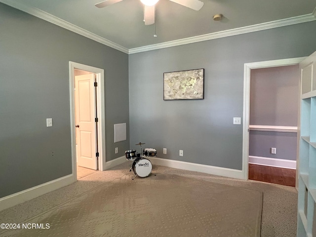 interior space featuring ceiling fan and crown molding