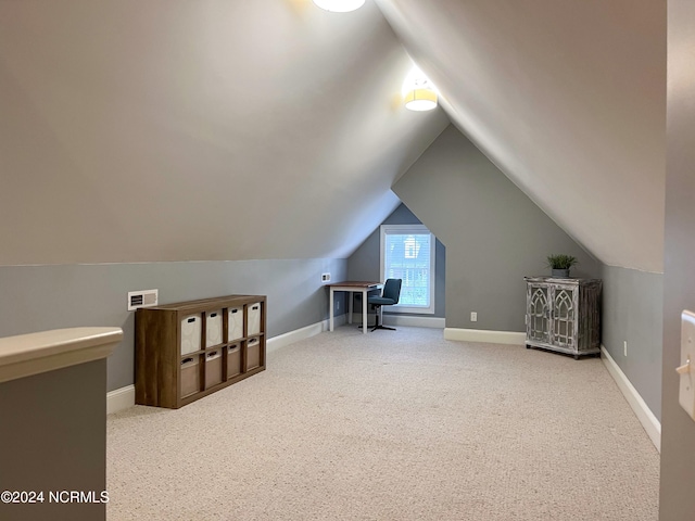 additional living space featuring carpet flooring and lofted ceiling