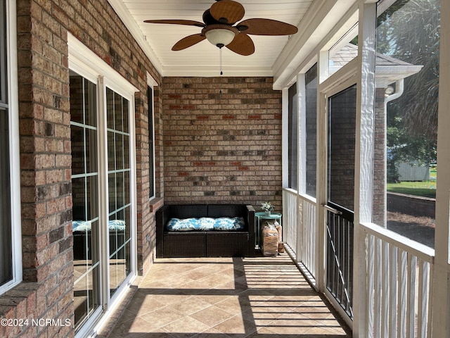 unfurnished sunroom featuring ceiling fan