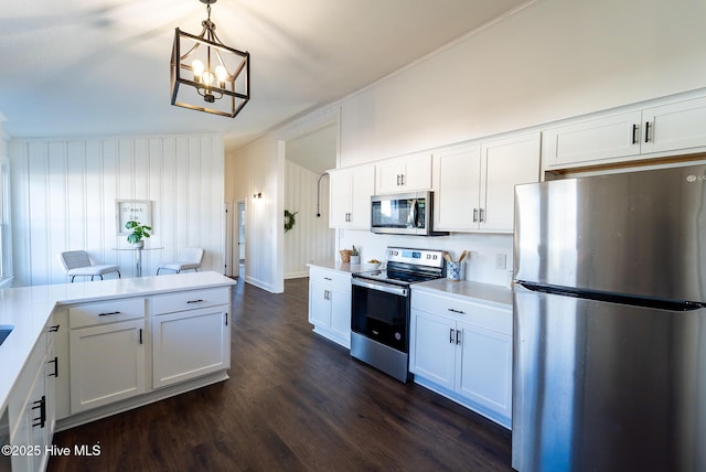 kitchen with pendant lighting, white cabinetry, and stainless steel appliances