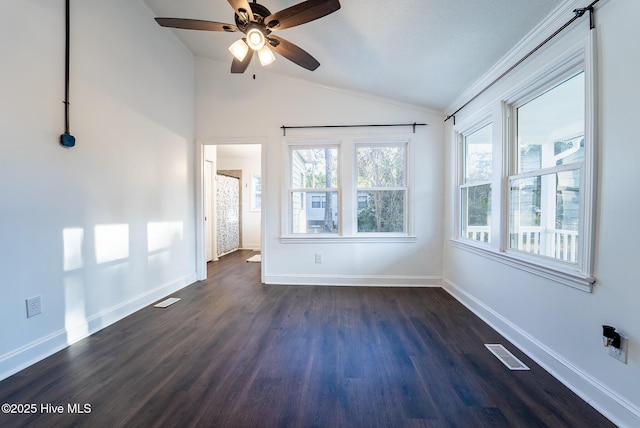 spare room with lofted ceiling, ceiling fan, dark hardwood / wood-style flooring, and a wealth of natural light