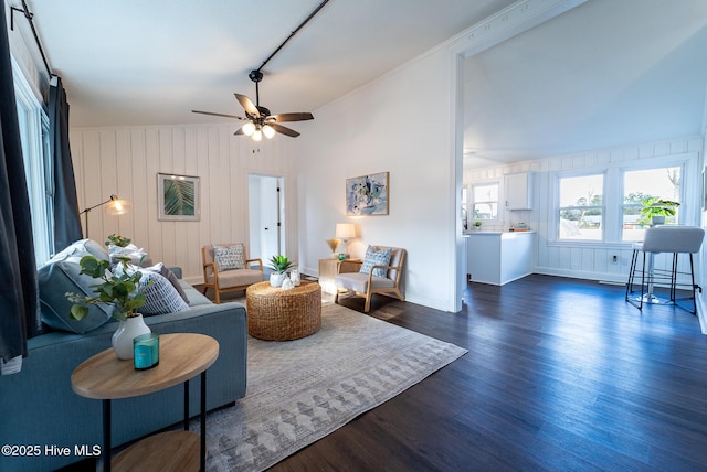 living room with ceiling fan and dark hardwood / wood-style flooring