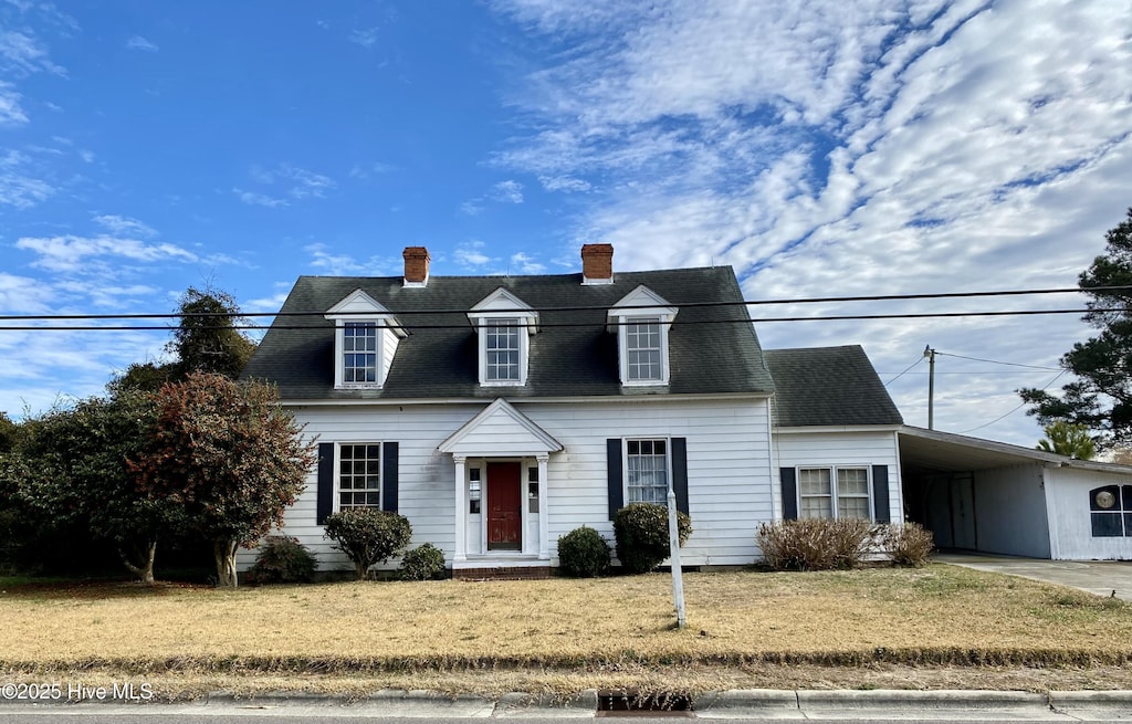 view of front of property with a front yard and a carport