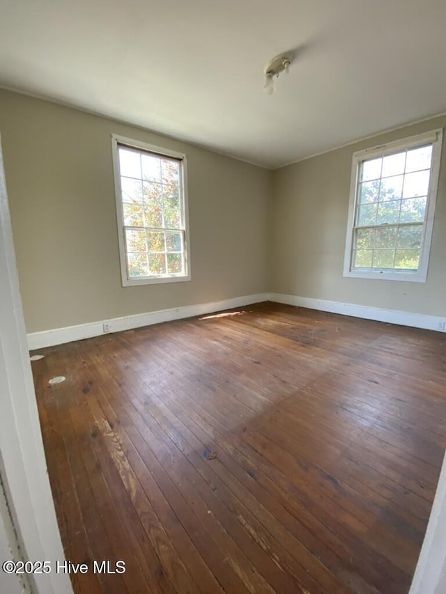4313 Caratoke Hwy, Barco, NC 27917 - spare room featuring baseboards, dark wood-style floors, and a wealth of natural light