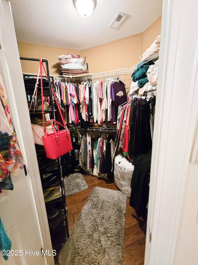 spacious closet featuring hardwood / wood-style flooring