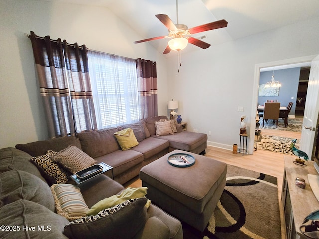 living room featuring wood-type flooring, lofted ceiling, and ceiling fan