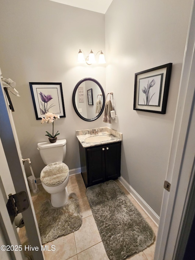 bathroom featuring tile patterned flooring, vanity, and toilet