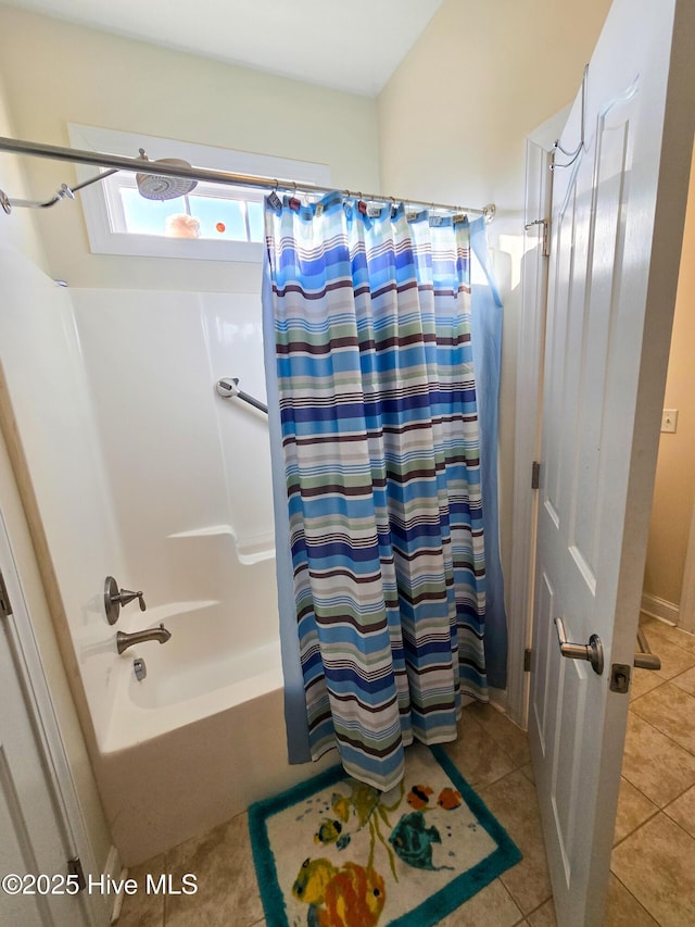 bathroom featuring shower / bath combination with curtain and tile patterned floors