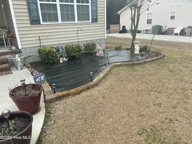 view of yard featuring central air condition unit